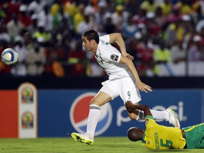 Algeria's Ishak Belfodil, left, is challenged by South Africa's Anele Ngcongca, during the African Cup of Nations Group C soccer match between Algeria and South Africa in Mongomo, Equatorial Guinea, Monday, Jan. 19, 2015. (AP Photo/Themba Hadebe)