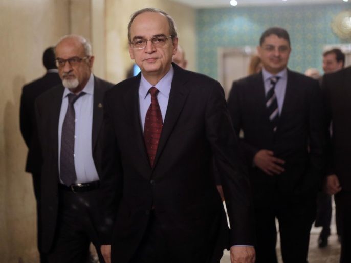 Hadi Bahra, the head of the Syrian National Coalition, the country's main political opposition group, leaves a meeting with Arab League's Secretary-General Nabil Elaraby at the league's headquarters in Cairo, Egypt, Saturday, Dec. 27, 2014. (AP Photo/Amr Nabil)