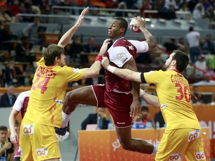 Rafael Capote of Qatar (C) is blocked by Viran Morros (L) and Gedeon Guardiola (R) of Spain during their preliminary round of the 24th men's handball World Championship in Doha January 21, 2015. REUTERS/Mohammed Dabbous (QATAR - Tags: SPORT HANDBALL)