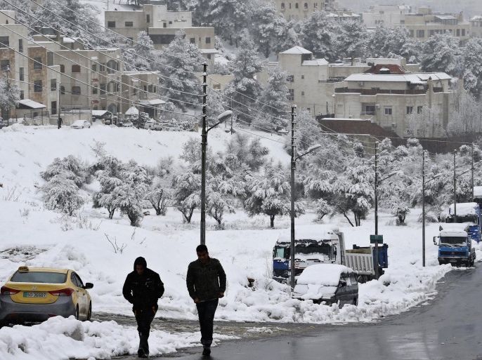A Jordanian man walks down a street covered with snow during a snowstorm in Amman January 9, 2015. A storm buffeted the Middle East with blizzards, rain and strong winds, keeping people at home across much of the region and raising concerns for Syrian refugees facing freezing temperatures in flimsy shelters. The storm is forecast to last several days, threatening further disruption in Lebanon, Syria, Turkey, Jordan, Israel, the West Bank and the Gaza Strip, which have all been affected. REUTERS/Muhammad Hamed (JORDAN - Tags: ENVIRONMENT)