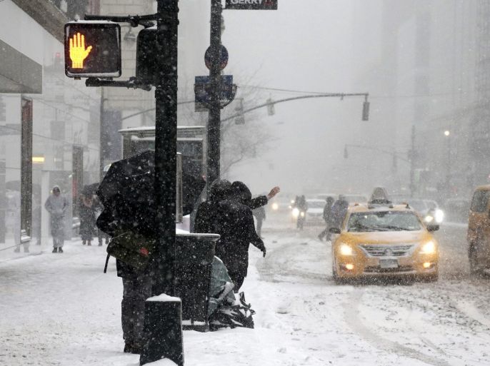 Two people hailing a taxi during a winter storm in New York, New York, USA, 26 January 2015. Areas of the New York metropolitan region were expected to get up to 2 feet (60 cm) of snow.