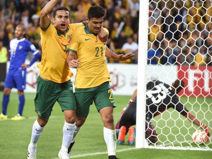 Australia's Massimo Luongo (C) is congratulated by teammate Tim Cahill (2nd L) after scoring against Kuwait during the opening football match of the AFC Asian Cup in Melbourne on January 9, 2015. AFP PHOTO / William WEST --IMAGE RESTRICTED TO EDITORIAL USE - STRICTLY NO COMMERCIAL USE--