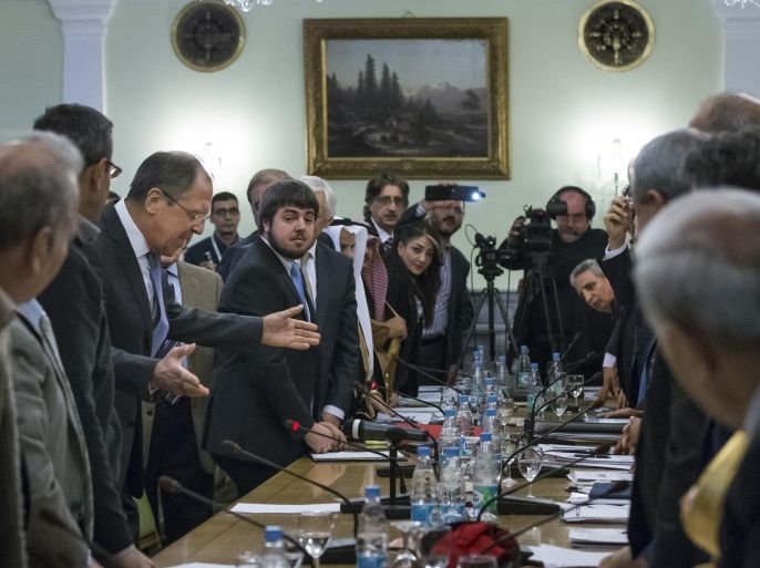 Russian Foreign Minister Sergey Lavrov, gesturing at center left, welcomes participants of consultations between representatives of the Syrian government and the Syrian opposition in Moscow, Russia, Wednesday, Jan. 28, 2015. Lavrov said the meeting should pave the way for further talks on conditions for a political settlement. (AP Photo/Alexander Zemlianichenko)