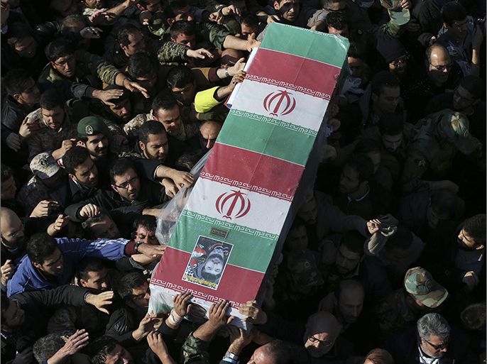 Civilians and armed forces members carry the flag draped coffin of Iranian Revolutionary Guard Brig. Gen. Mohammad Ali Allahdadi during his funeral ceremony outside the Guard compound in Tehran, Iran, Wednesday, Jan. 21, 2015. Iran's Revolutionary Guard said Wednesday that Israel will be punished for killing one of its generals in an airstrike in Syria that also killed six Lebanese Hezbollah fighters. (AP Photo/Vahid Salemi)