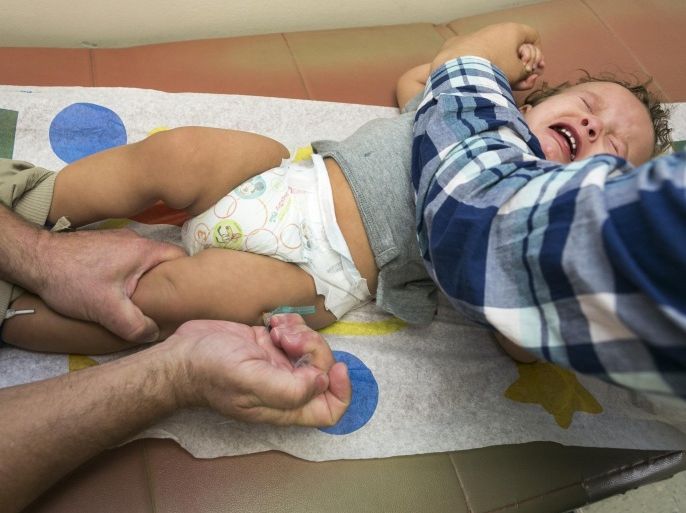 FILE - In this Jan. 29, 2015, file photo, pediatrician Dr. Charles Goodman vaccinates 1 year- old Cameron Fierro with the measles-mumps-rubella vaccine, or MMR vaccine at his practice in Northridge, Calif. The Centers for Disease Control and Prevention reported Tuesday, Feb. 17, 2015, that the number of U.S. measles cases this year has risen to 141, with most of the new illnesses tied to outbreaks at Disneyland in California and an Illinois day care center. (AP Photo/Damian Dovarganes, File)