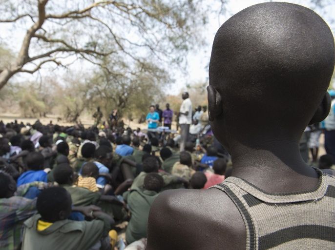 Young boys, children soldiers attend on February 10, 2015 a ceremony of the child soldiers disarmament, demobilisation and reintegration in Pibor oversawn by UNICEF and partners. UNICEF and its partners have overseen the release of another 300 children from the Cobra Faction armed group of former rebels of David Yau Yau. The children in Pibor, Jonglei State, surrendered their weapons and uniforms in a ceremony overseen by the South Sudan National Disarmament, Demobilization and Reintegration Commission, and the Cobra Faction and supported by UNICEF. They were to spend their first night in an interim care center where they will be provided with food, water and clothing. They will also have access to health and psychosocial services. AFP PHOTO/Charles LOMODONG