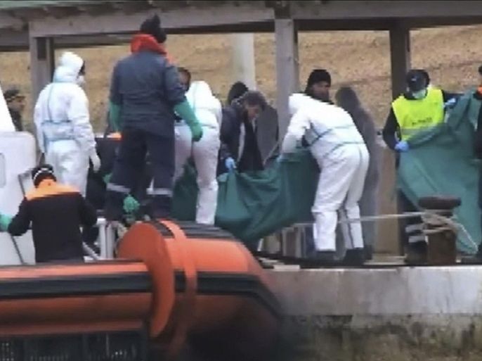 ATTENTION EDITORS - VISUAL COVERAGE OF SCENES OF INJURY OR DEATHCoast guard officers carry the body of a migrant in a body bag off a coast guard boat in the Lampedusa harbour, in this still image taken from video shot on February 9, 2015. Twenty-nine migrants died of hypothermia aboard Italian coast guard vessels after being picked up from an inflatable boat adrift near Libya, reigniting criticism of the government's decision to end a full-scale search-and rescue mission last year. Video shot February 9. REUTERS/Vista via Reuters TV (ITALY - Tags: SOCIETY IMMIGRATION POLITICS TPX IMAGES OF THE DAY DISASTER) ATTENTION EDITORS - THIS PICTURE WAS PROVIDED BY A THIRD PARTY. REUTERS IS UNABLE TO INDEPENDENTLY VERIFY THE AUTHENTICITY, CONTENT, LOCATION OR DATE OF THIS IMAGE. NO SALES. NO ARCHIVES. FOR EDITORIAL USE ONLY. NOT FOR SALE FOR MARKETING OR ADVERTISING CAMPAIGNS. ITALY OUT. NO COMMERCIAL OR EDITORIAL SALES IN ITALY. NO ACCESS .IT WEBSITES.TEMPLATE OUT