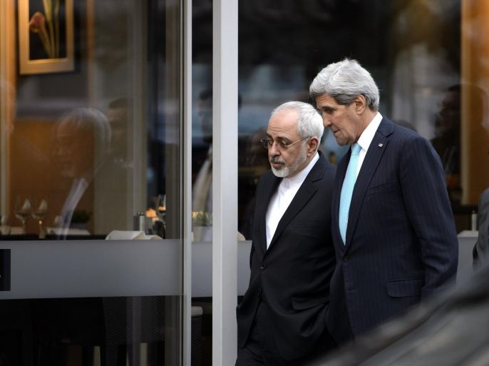 US Secretary of State John Kerry, right, speaks with Iranian Foreign Minister Mohammad Javad Zarif, as they walk in the city of Geneva, Switzerland, Wednesday, Jan. 14, 2015, during a bilateral meeting ahead of the next round of nuclear discussion. (AP Photo/Keystone,Martial Trezzini)