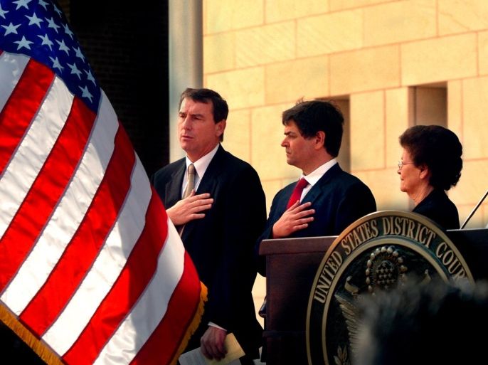 FILE- In this Nov. 14, 2005, file photo, U.S. Southern District Judge Andrew S. Hanen, left, joins with Filemon B. Vela, Jr. and Blanca Vela for the Pledge of Allegiance during the United States Courthouse naming ceremony in Brownsville, Texas. Hanen temporarily blocked President Barack Obama’s executive action on immigration Monday, Feb. 16, 2015, giving a coalition of 26 states time to pursue a lawsuit that aims to permanently stop the orders. (AP Photo/The Brownsville Herald, Brad Doherty, File)
