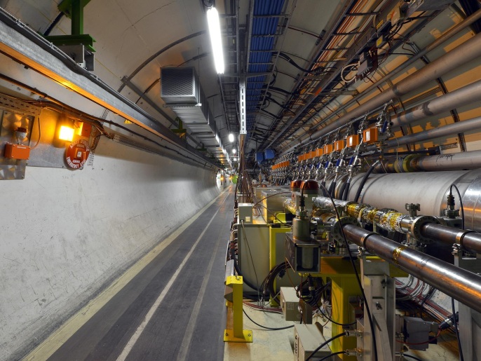 GENEVA, SWITZERLAND - SEPTEMBER 02: The LHC tunnel, part of the CERN LHC experiment on September 2, 2014 in Geneva, Switzerland. The European Organization for Nuclear Research (CERN), which has 21 member states, has built amongst other experiments the Large Hadron Collider (LHC). The world's largest atom collider has been investigating antimatter, dark matter and the creation of the universe. Built around a 27 kilometre underground ring of superconducting magnets where two high-energy particle beams travel at close to the speed of light in opposite directions before they are made to collide at four particle detectors.