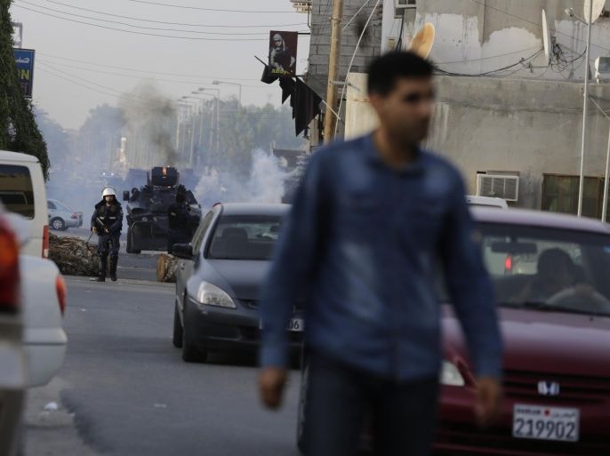 Riot police fire tear gas to disperse Bahraini protesters after the funeral of Sayed Mohamed Sayed Kadhim, in Saar, Bahrain, Friday, Feb. 20, 2015. Mourners chanted anti-government slogans during a politically charged funeral procession. Relatives and opposition groups said Sayed Mohammed died from heavy teargas during earlier clashes in the village. Clashes erupted when angry protesters clashed with police surrounding the village after the funeral. (AP Photo / Hasan Jamali)