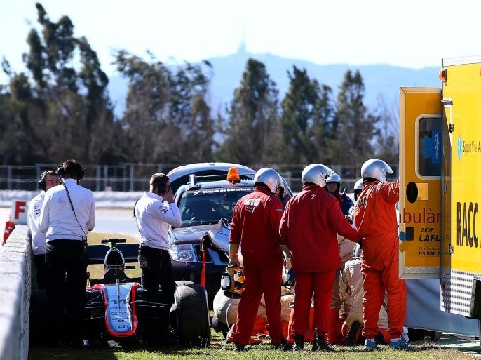 MONTMELO, SPAIN - FEBRUARY 22: Fernando Alonso of Spain and McLaren Honda receives medical assistance after crashing during day four of Formula One Winter Testing at Circuit de Catalunya on February 22, 2015 in Montmelo, Spain.