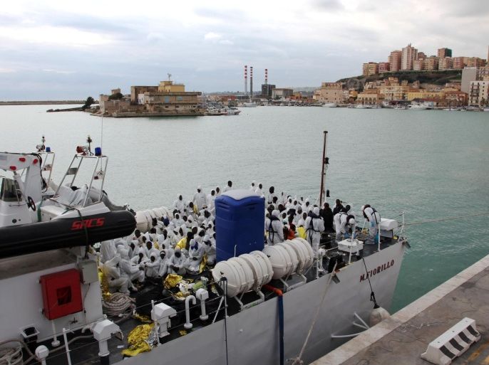 Migrants wait to disembark from an Italian Coast Guard ship after being rescued in Porto Empedocle, Sicily, southern Italy, Saturday, Feb. 14, 2015. The U.N. High Commissioner for Refugees, Save the Children, Amnesty International and other aid groups blasted the new EU-backed rescue patrol as insufficient for the task at hand. The European Union took over Mediterranean patrols after Italy phased out its robust Mare Nostrum operation in November. Mare Nostrum (Our Seas) had been launched in 2013 after 360 migrants drowned off the coast of the Sicilian island of Lampedusa. But the EU's Triton mission only operates a few miles off Europe's coast — its job is to patrol Europe's borders — whereas Mare Nostrum patrols took Italian rescue ships up close to Libya's coast. (AP Photo/Francesco Malavolta)