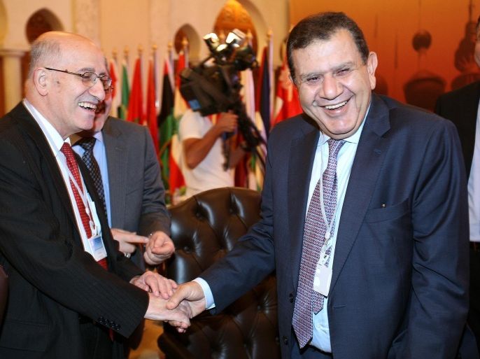 Sinan al-Shabibi, governor of the Central Bank of Iraq, (L) shakes hands with Ziad Fariz, governor of the Central Bank of Jordan, during a meeting of Arab central bank governors in Kuwait City on October 1, 2012. The head of the Arab Monetary Fund said that the Arab Spring uprisings and the global financial crisis have hit hard the economies of countries struck by revolts over the past years.