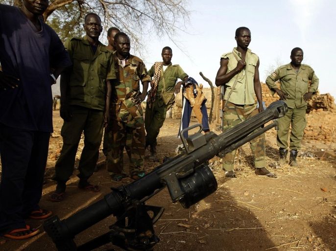 SPLA-N fighters stand in front of a grenade launcher captured from Sudan's Armed Forces (SAF) near Gos village in the rebel-held territory of the Nuba Mountains in South Kordofan, May 1, 2012. REUTERS/Goran Tomasevic (SUDAN - Tags: CIVIL UNREST)