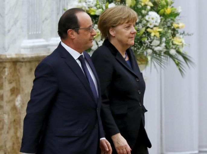 German Chancellor Angela Merkel, right, and French President Francois Hollande head for talks in Minsk, Belarus, Wednesday, Feb. 11, 2015. Leaders of Russia, Ukraine, France and Germany are gathering for crucial talks in the hope of negotiating an end fighting between Russia-backed separatist and government forces in eastern Ukraine. (AP Photo/Sergei Grits)