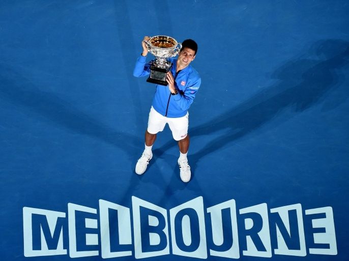 Novak Djokovic of Serbia celebrates with the trophy after his win against Andy Murray of Britain in the Men's final match at the Australian Open Grand Slam tennis tournament in Melbourne, Australia, 01 February 2015. EPA/JOE CASTRO AUSTRALIA AND NEW ZEALAND OUT