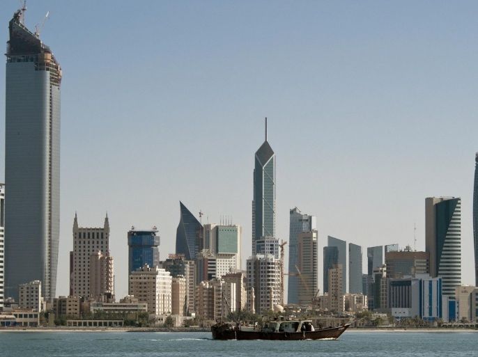 A fishing boat passes in front of the Kuwait City skyline September 11, 2010.
