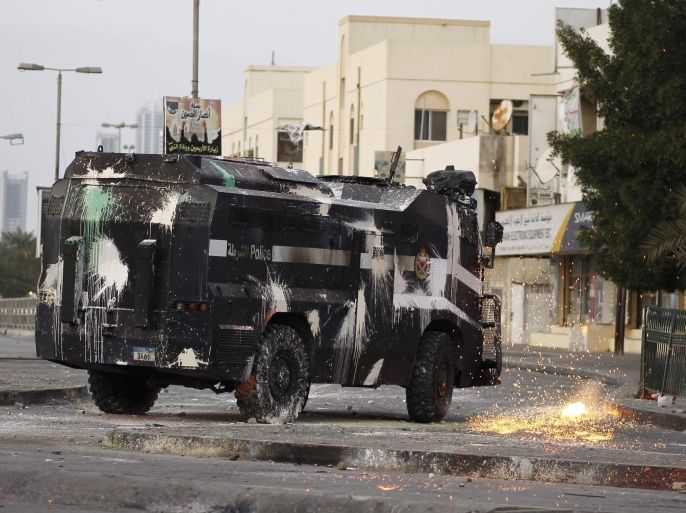 A Molotov, thrown by a protester, explodes on the ground beside a riot police armoured personnel carrier during clashes in the village of Bilad Al Qadeem south of Manama, January 12, 2015. Protesters were demonstrating to demand the release of Ali Salman, the head of Bahrain's main opposition party Al Wefaq, who was detained after being summoned for interrogation by the Interior Ministry on December 28, 2014, setting off a wave of public disapproval. REUTERS/Hamad I Mohammed (BAHRAIN - Tags: POLITICS CIVIL UNREST)