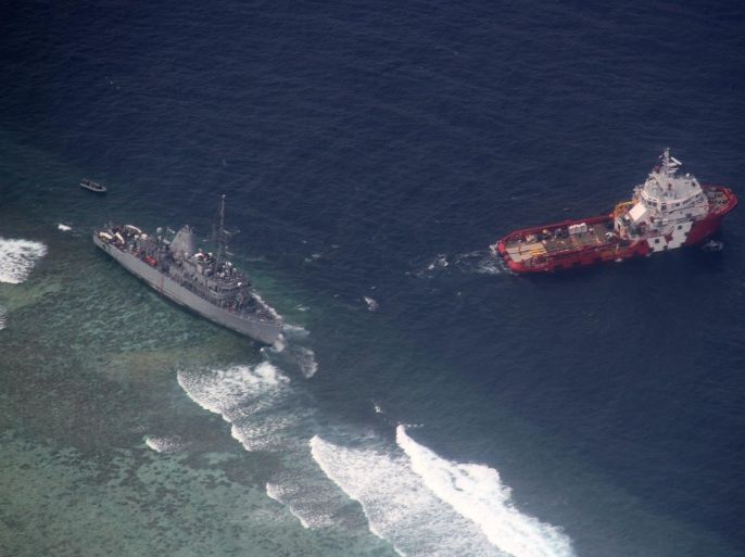 (FILE) A file picture dated 24 January 2013, shows an aerial view of the Malaysian tug boat Vos Apollo (R) preparing to remove fuel and other equipment from the US Navy ship USS Guardian (L), which ran aground in the vicinity of Tubbataha Reef, western Philippines. The US has paid the Philippines 1.97 million US dollar for damages caused by the grounding of a US Navy ship on Tubbataha Reefs in 2013, the Philippine Department of Foreign Affairs (DFA) said on 18 February 2015. The government received the payment on 20 January 2015, the DFA said. The USS Guardian grounded on 17 January 2013, damaging more than 2,000 square meters of protected reefs. The Tubbataha Reefs in the Sulu Sea are a protected area and they are among the world's most important marine sanctuaries. 'The compensation will be utilized for the protection and rehabilitation of Tubbataha Reef Natural Park, a UNESCO World Heritage Site,' the DFA said in a statement. EPA/MARTIN CUENCA BEST QUALITY AVAILABLE