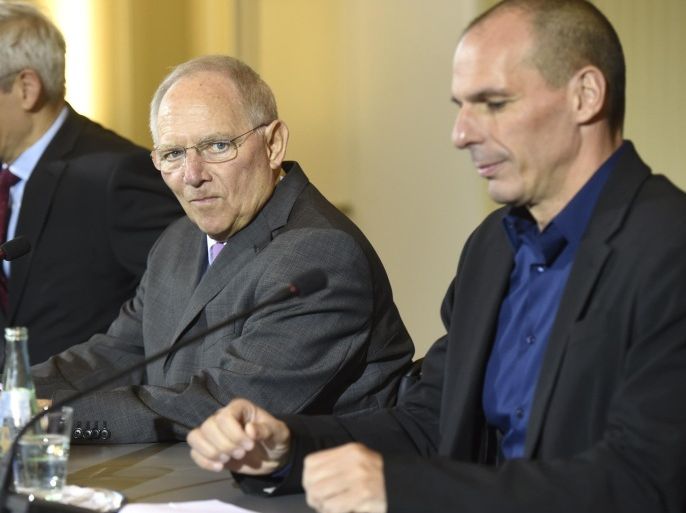 Greece's new Finance Minister Yanis Varoufakis (R) and his German counterpart Wolfgang Schaeuble (C) give a joint press conference with German Finance Ministry Spokesman Martin Jaeger (L) following their meeting on February 5, 2015 at the Finance ministry in Berlin. The new Greek finance minister's stop in Berlin follows a high-stakes visit to ECB headquarters in Frankfurt to try to drum up support for the new anti-austerity government's debt relief bid. AFP PHOTO / ODD ANDERSEN