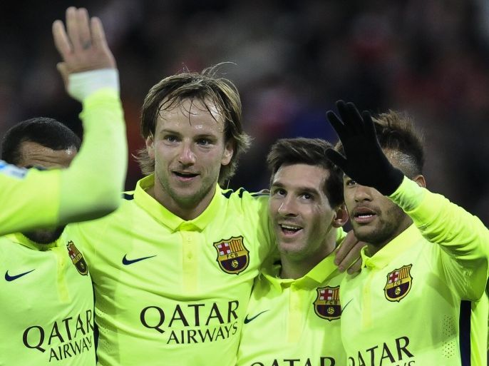 FC Barcelona's Lionel Messi of Argentina, second right, celebrates scoring his second and the fifth goal of the match against Athletic Bilbao with teammates during their La Liga soccer match, at San Mames stadium in Bilbao, northern Spain, Sunday, Feb. 8, 2015. (AP Photo/Alvaro Barrientos)