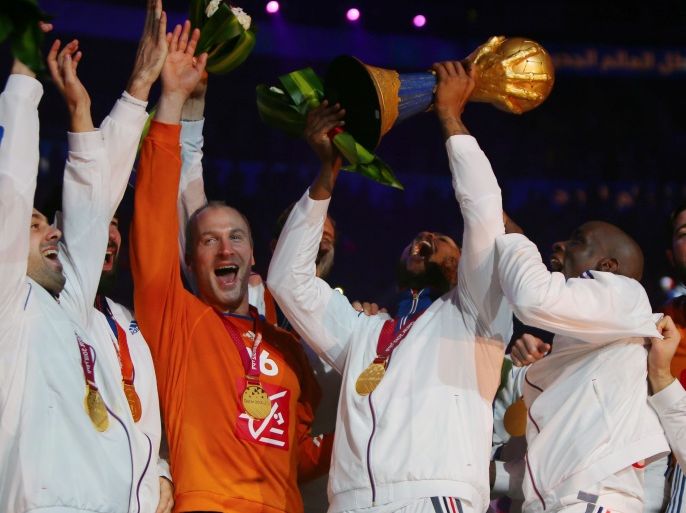 581 - Doha, -, QATAR : French players celebrate with the trophy during the podium ceremony of 24th Men's Handball World Championships at the Lusail Multipurpose Hall in Doha on February 1, 2015. France became the first team in handball history to win five world championships when they beat surprise finalists Qatar 25-22. AFP PHOTO / MARWAN NAAMANI