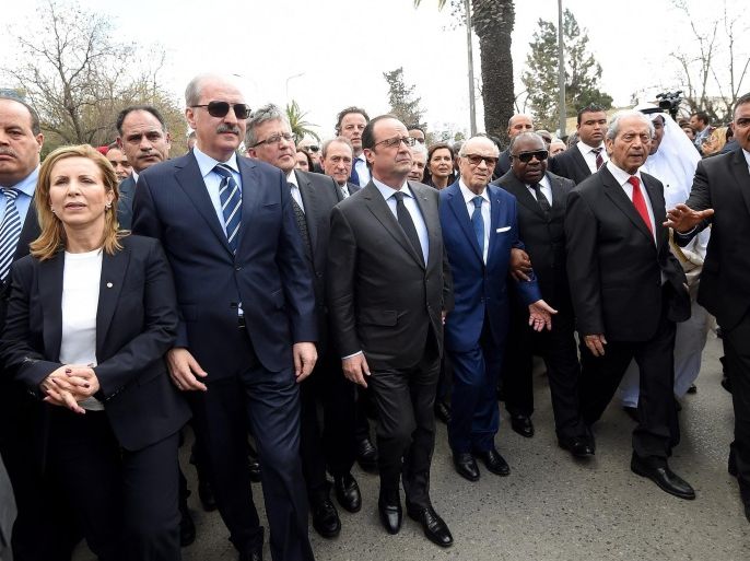 Tunisian President Beji Caid Essebsi (C-R) and French President Francois Hollande (C-L) lead an anti-extremism march, in Tunis, Tunisia, 29 March 2015. Thousands of Tunisians took part in a march in the capital Tunis to denounce terrorism, more than a week after an attack on the national museum left 20 foreign visitors dead. The marchers, waving the national flag, started their rally from central Tunis heading to the Bardo Museum where the March 18 attack occurred.