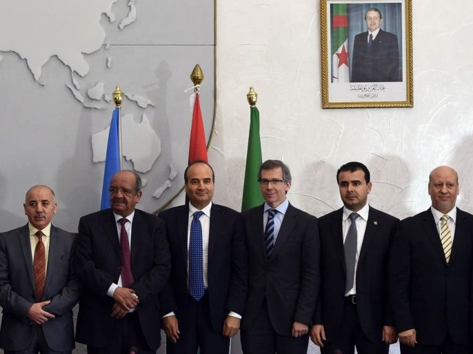 United Nations Special Representative and Head of the United Nations Support Mission in Libya, Bernardino Leon (6th from L), poses with representatives of Libyan political leaders and activists in the Algerian capital Algiers on March 11, 2015, during talks aimed at ending the violence that has plagued Libya since the 2011 NATO-backed uprising. AFP PHOTO / FAROUK BATICHE