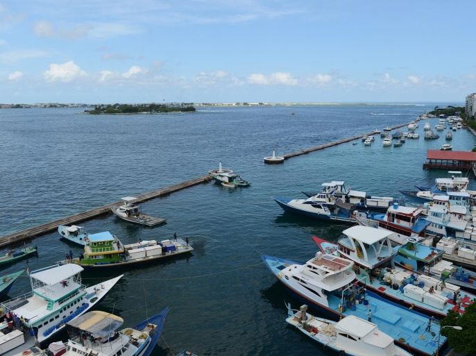 Moored boats are seen from the jetty on the island of Male, the capital of the Maldives, on October 26, 2014. The tiny Indian Ocean atoll nation depends on imports to sustain its successful luxury tourism sector. AFP PHOTO / LAKRUWAN WANNIARACHCHI