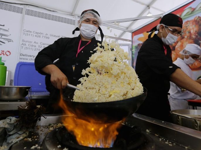 A cook prepares rice during the Mistura gastronomic fair in Lima, September 5, 2014. The fair seeks to promote Peruvian cuisine by showcasing food and products from all over the country. Exponents of Peruvian cuisine and foreign chefs are also participating in the fair, which runs from September 4 to 14. REUTERS/Mariana Bazo (PERU - Tags: SOCIETY BUSINESS FOOD)