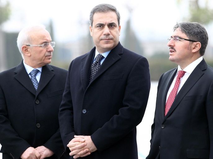 This file picture taken on December 19, 2014 shows the head of Turkey's intelligence agency Hakan Fidan (C) standing in Ankara. The powerful head of Turkey's intelligence agency, one of the most loyal allies of President Recep Tayyip Erdogan, has resigned to stand for election as a lawmaker, the official Anatolia news agency said on February 7, 2015. The resignation of Hakan Fidan, who has headed the National Intelligence Agency (MIT) since 2010, has been accepted by Prime Minister Ahmet Davutoglu and will take effect on February 10, 2015, it added. AFP PHOTO / ADEM ALTAN