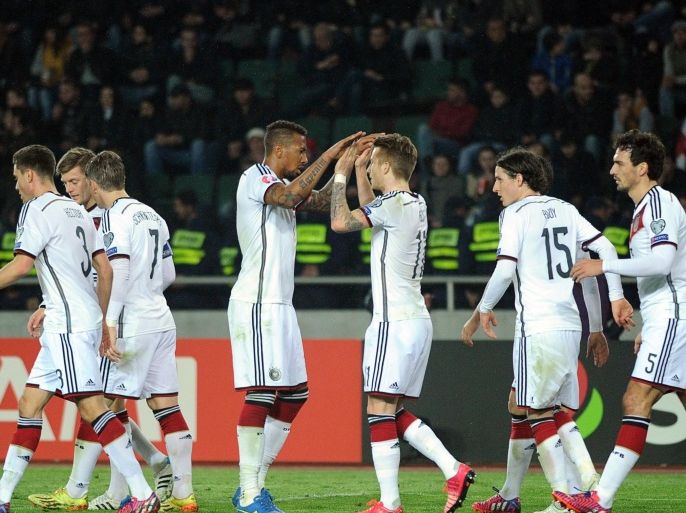 Germany's defender Jerome Boateng and Germany's midfielder Marco Reus (center L-R) celebrate their team's goal during the Euro 2016 qualifying football match between Georgia and Germany in Tbilisi on March 29, 2015. AFP PHOTO / VANO SHLAMOV