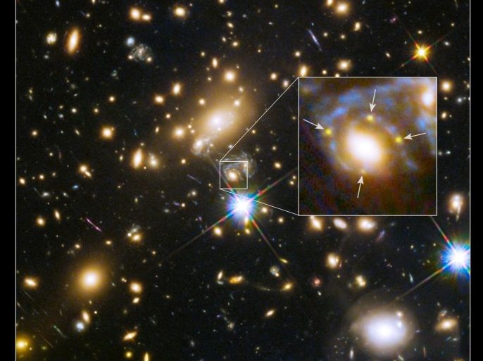 Multiple images of a single distant supernova within a cluster of galaxies called MACS J1149.6+2223, located more than 5 billion light-years away, are seen in an image from NASA taken by the Hubble Space Telescope released March 5, 2015. In the enlarged inset view of the galaxy, the arrows point to the multiple copies of the exploding star, dubbed Supernova Refsdal, located 9.3 billion light-years from Earth. The images are arranged around the galaxy in a cross-shaped pattern called an Einstein Cross. The blue streaks wrapping around the galaxy are the stretched images of the supernova's host spiral galaxy, which has been distorted by the warping of space. REUTERS/NASA/Handout via Reuters (OUTER SPACE - Tags: SCIENCE TECHNOLOGY) THIS IMAGE HAS BEEN SUPPLIED BY A THIRD PARTY. IT IS DISTRIBUTED, EXACTLY AS RECEIVED BY REUTERS, AS A SERVICE TO CLIENTS. FOR EDITORIAL USE ONLY. NOT FOR SALE FOR MARKETING OR ADVERTISING CAMPAIGNS