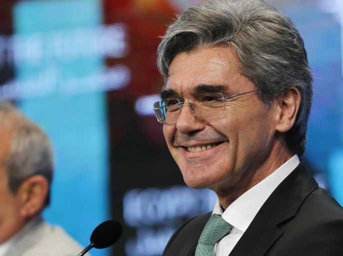Joe Kaeser (R), chief executive of German industrial group Siemens, smiles during the Egypt Economic Development Conference (EEDC) in Sharm el-Sheikh, in the South Sinai governorate, south of Cairo, March 14, 2015. REUTERS/Amr Abdallah Dalsh (EGYPT - Tags: BUSINESS POLITICS)