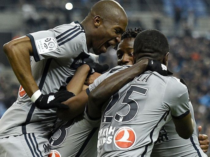 Marseille's Ghanaian forward Andre Ayew (C) celebrate with teammates after scoring a goal during the French L1 football match between Lens and Marseille on March 22, 2014 at the Stade de France in Saint-Denis, north of Paris. AFP PHOTO / FRANCK FIFE