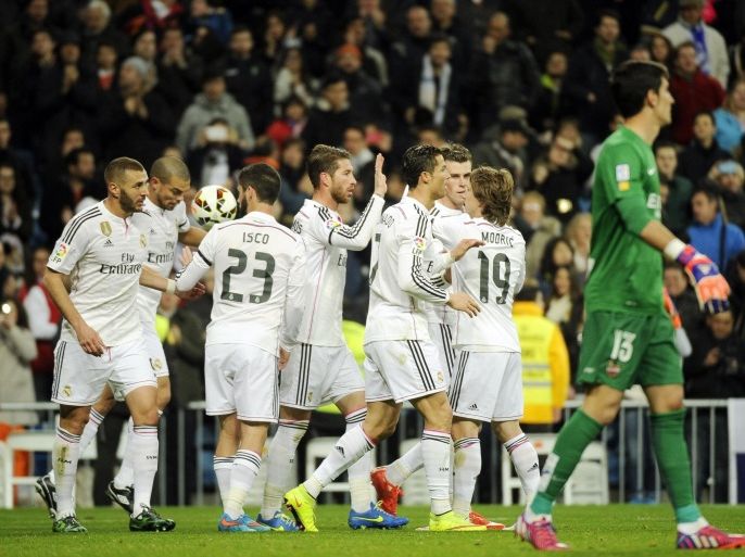 Real Madrid's players celebrate their second goal during the Spanish league football match Real Madrid CF vs Levante UD at Santiago Bernabeu stadium in Madrid on March 15, 2015. AFP PHOTO / PEDRO ARMESTRE