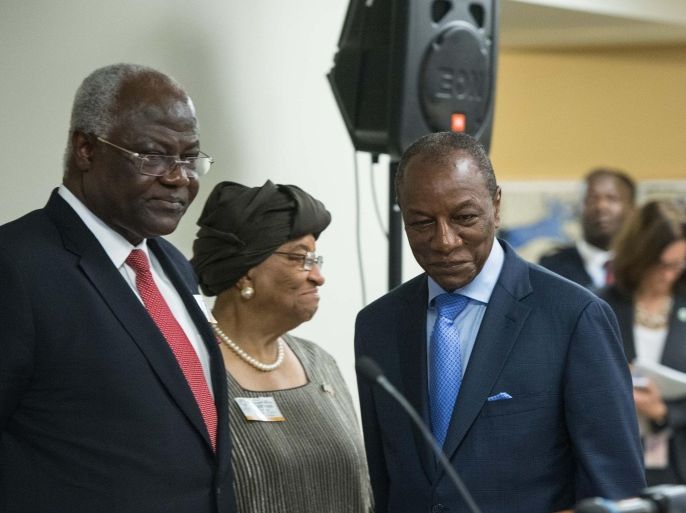 Guinean President Alpha Conde (R) walks past Sierra Leone President Ernest Bai Koroma (L) and Liberian President Ellen Johnson Sirleaf (C) to speak to the press following a meeting on the response to the Ebola crisis at the IMF/WB Spring Meetings in Washington, DC, on April 17, 2015. AFP PHOTO/NICHOLAS KAMM