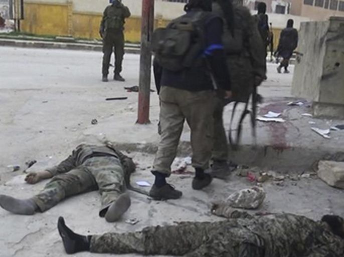 In this image posted on the Twitter page of Syria's al-Qaida-linked Nusra Front on Saturday, March 28, 2015, which is consistent with AP reporting, fighters from Syria's al-Qaida-linked Nusra Front walk by bodies of Syrian government forces soldiers in Idlib province, north Syria. Al-Qaida's affiliate in Syria, the Nusra Front, captured most of the northwestern city of Idlib from government forces Saturday, sweeping into neighborhoods in the center of the city in a powerful blow to President Bashar Assad's government, opposition activists and the group said. (AP Photo/Nusra Front on Twitter)