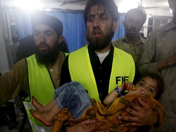 A child is taken to Leady Reading Hospital for treatment after torrential rains caused flooding and houses to collapse in Peshawar, Pakistan, April 26, 2015. REUTERS/Fayaz Aziz
