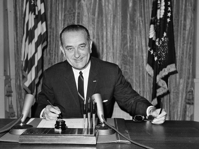 FILE - In this Aug. 10, 1964 file photo, President Lyndon B Johnson signs the Joint Resolution for the Maintenance of International Peace and Security, also known as the Gulf of Tonkin Resolution, backing his firm stand against aggression in Southeast Asia, in the East Room of the White House in Washington. Fifty years ago Sunday, Aug. 10, 2014, reacting to reports of a U.S. Navy encounter with enemy warships in the Gulf of Tonkin off Vietnam, Johnson signed the resolution that historians call the crucial catalyst for deep American involvement in the Vietnam War. (AP Photo/John Rous, File)
