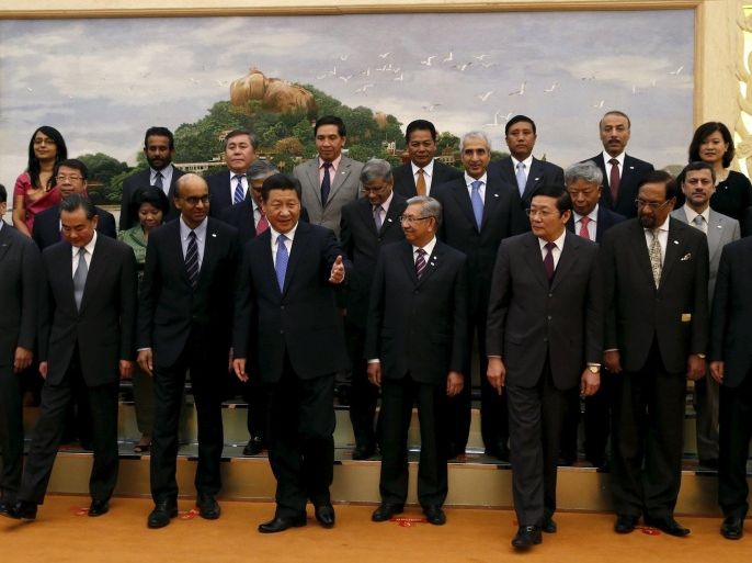 China's President Xi Jinping (front C) guides guests at the Asian Infrastructure Investment Bank launch ceremony at the Great Hall of the People in Beijing in this October 24, 2014 file photo. South Korea expects to take a stake of 4 percent to 5 percent in the China-led Asian Infrastructure Investment Bank (AIIB), in which it is seeking to be a founding member, a deputy finance minister said on Monday. REUTERS/Takaki Yajima/Files