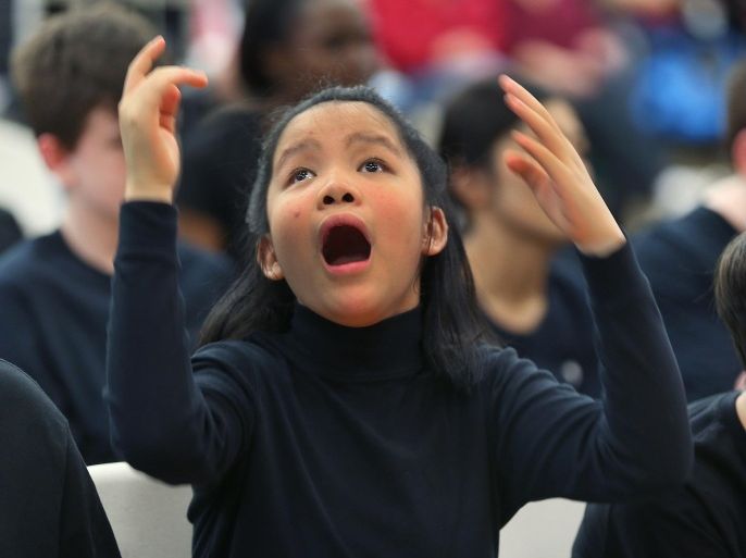RANDOLPH, MA - DECEMBER 19: Hope Knowlton, 12, has autism and expresses herself as she listens to a the song 'Someday at Christmas' being performed on stage by the chorus group during the Boston Higashi School's annual Winter Music Festival. The school serves children and young adults with autism. Hope's father said that she loves music. Nearly every student took part in the program.