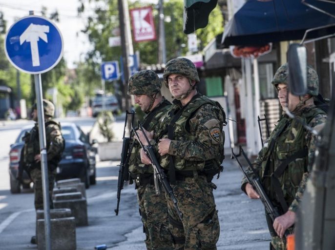 Macedonian police officers patrol in a street in the town of Kumanovo on May 10, 2015. Shooting broke out for a second day on May 10 in north Macedonia as concern mounted in Europe after clashes between police and unidentified gunmen that erupted on May 9 at dawn in the restive north of Macedonia. Eight policemen and 14 gunmen have been killed in two days of clashes, police said on Sunday. AFP PHOTO/ARMEND NIMANI
