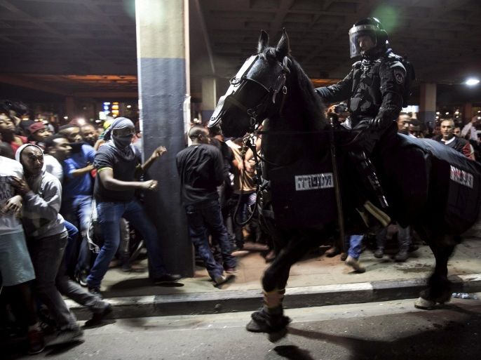 A mounted Israeli police officer tries to disperse protesters, some of Ethiopian descent, in Tel Aviv, Israel in this May 3, 2015 file photo. Images of Israeli police firing stun grenades are usually set in the West Bank and involve Palestinian protesters. But on Sunday the situation was quite different - riot police battling thousands of Ethiopian Jews in the centre of Tel Aviv.The spark was a week old video showing two Israeli policemen punching, beating and trying to arrest an Israeli soldier of Ethiopian descent in what appeared to be an unprovoked attack. REUTERS/Baz Ratner/Files
