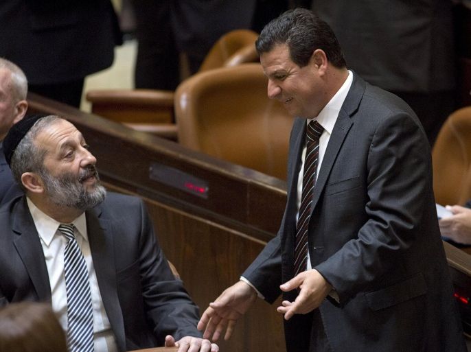 Aryeh Deri (L), party leader of the Ultra-Orthodox Shas party, speaks with Ayman Odeh, head of the Joint Arab List, during the swearing-in ceremony of the 20th Knesset, the new Israeli parliament, in Jerusalem March 31, 2015. REUTERS/Heidi Levine/Pool