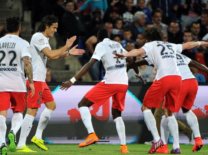 Paris Saint Germain players congratulate their French midfielder Blaise Matuidi (C) after he scored a goal during the French L1 football match between Montpellier (MHSC) and Paris Saint-Germain (PSG) on May 16, 2015 at La Mosson Stadium in Montpellier, southern France. AFP PHOTO / SYLVAIN THOMAS