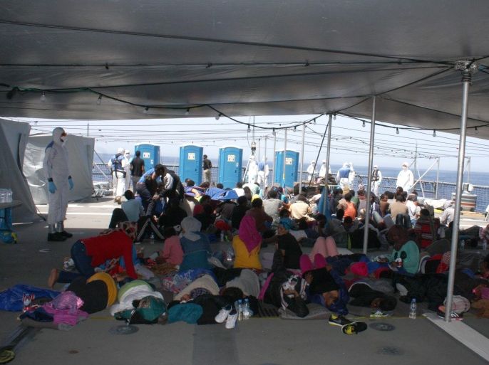A handout photo provided by the German Bundeswehr shows refugees on the deck of the "Hessen" in the Mediterranean sea, 130 nautical miles off the Italian island of Lampedusa, 08 May 2015. In their first deployment in the Mediterranean sea, Bundeswehr Marines with two ships rescued around 430 shipwrecked refugees. According to Joint Operations Command, the frigate 'Hessen' took around 250 people on board in international waters, including 30 women and 5 children. The refugees had been travelling in a wooden boat, which risked sinking 50 kilometers off the Libyan coast. EPA/PAO/Mittelmeer / HANDOUT