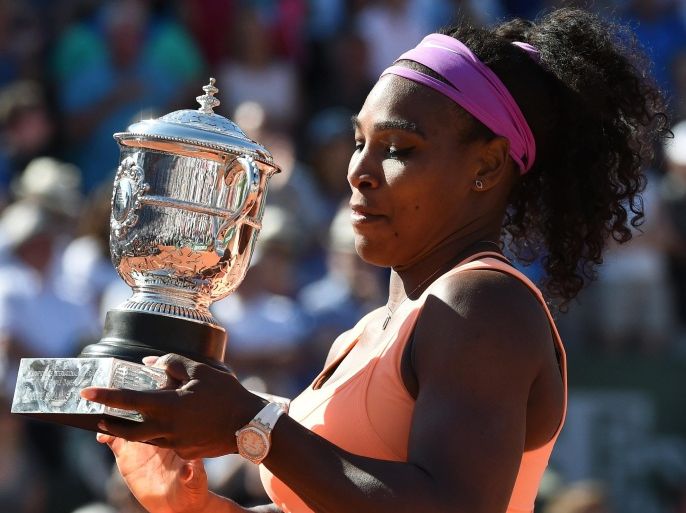 US Serena Williams celebrates with the trophy following her victory over Czech Republic's Lucie Safarova at the end of the women's final match of the Roland Garros 2015 French Tennis Open in Paris on June 6, 2015. AFP PHOTO / PASCAL GUYOT
