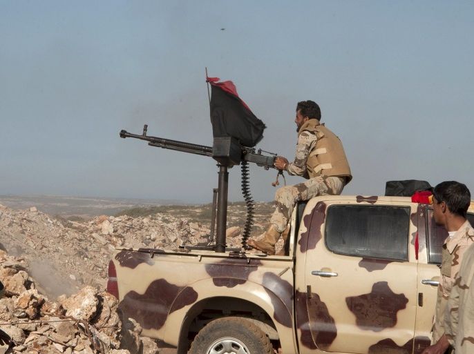 Members of the Libyan pro-government forces, aim a weapon during their deployment in the Lamluda area, southwest of the city of Derna , Libya June 16, 2015. Picture taken June 16, 2015. REUTERS/Stringer